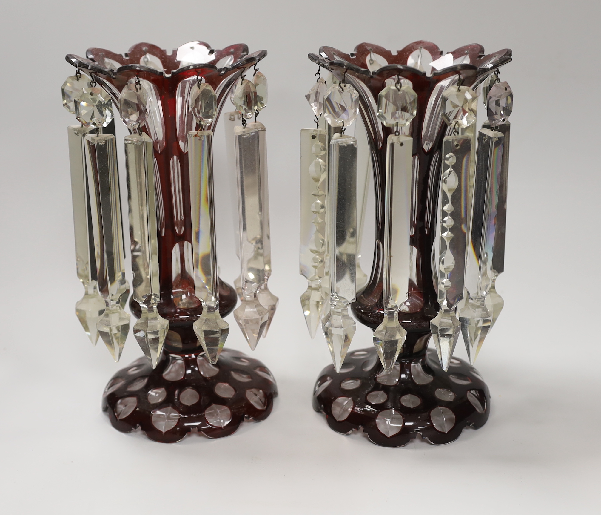 A pair of Victorian ruby overlaid glass table lustres, 28cm